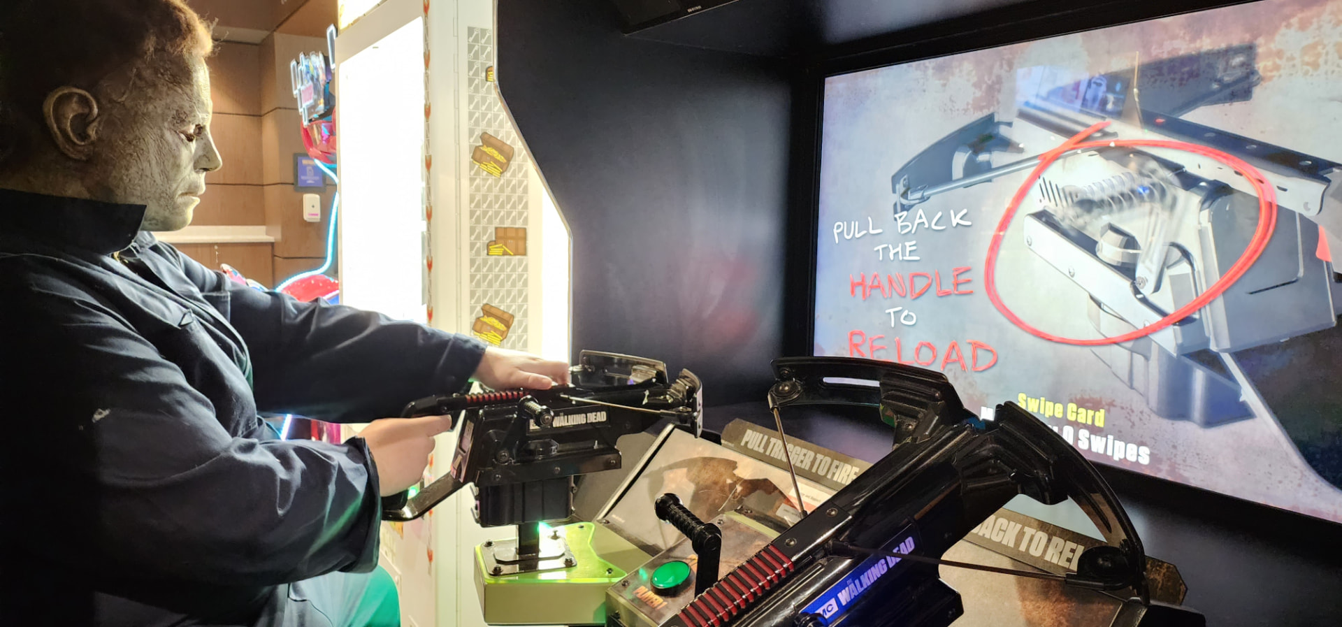 Actor dressed as Michael Myers playing an arcade crossbow game