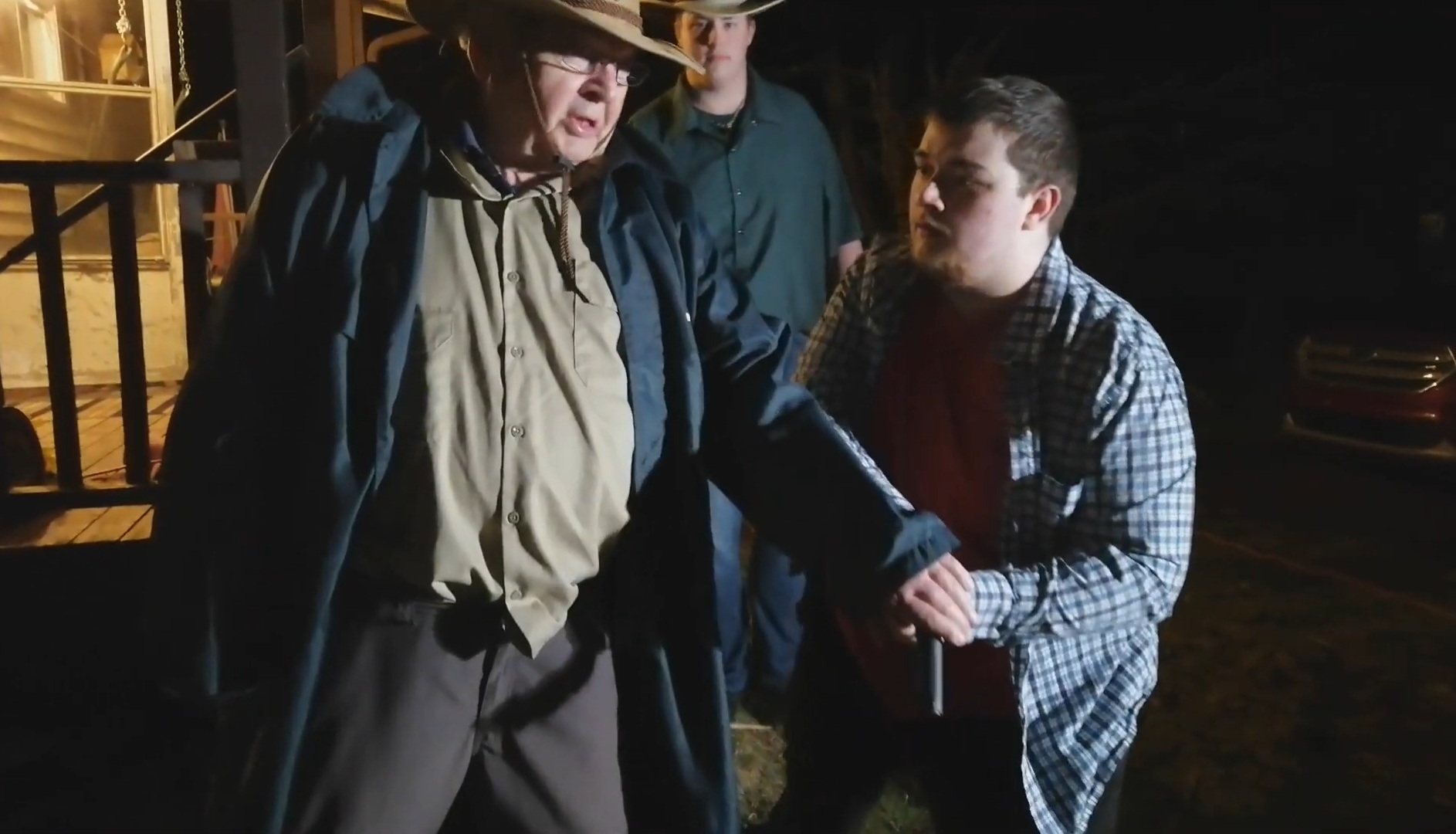 Cast members filming a western scene at night