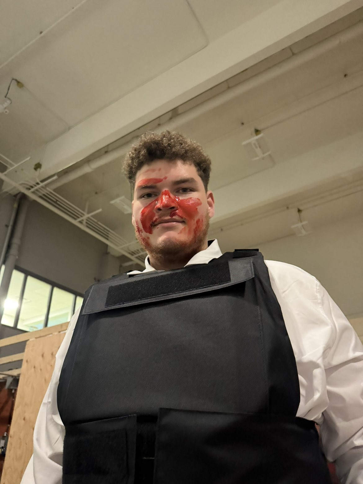 Actor in protective costume wearing action-scene makeup