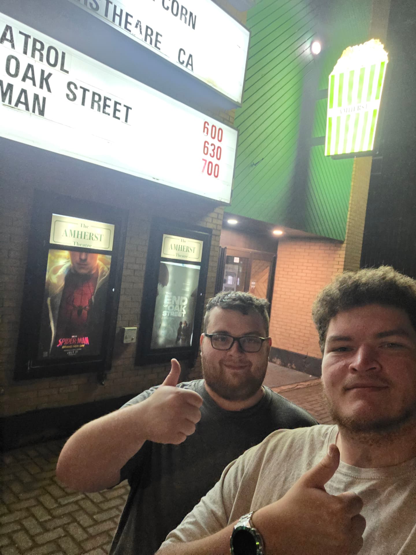 Two crew members outside the Amherst Theatre