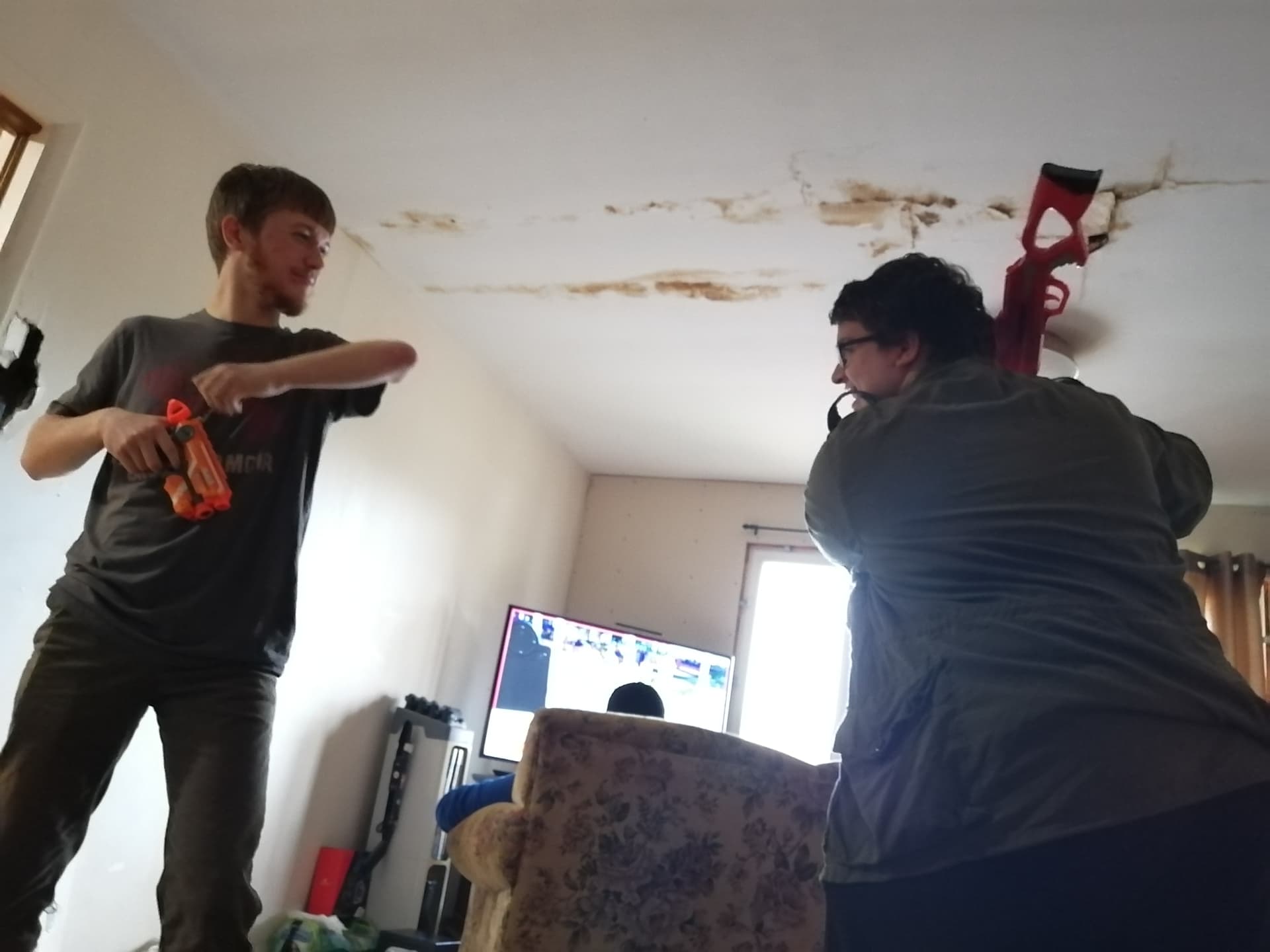 Two performers rehearsing an action scene with prop weapons