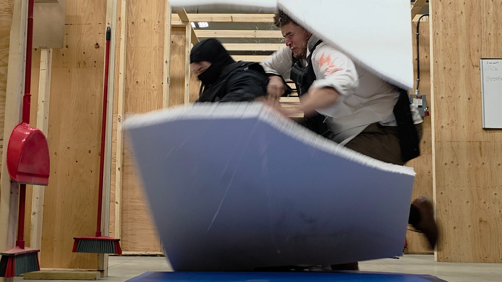 Actors rehearsing an action sequence with a crash mat